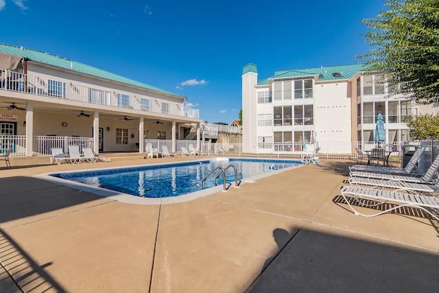 view of pool with a patio and ceiling fan