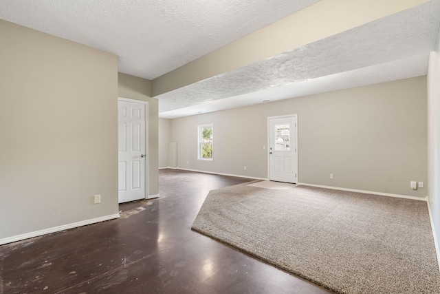 empty room featuring baseboards and a textured ceiling