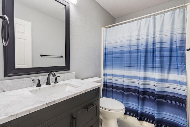 full bath with toilet, a textured ceiling, a textured wall, and vanity