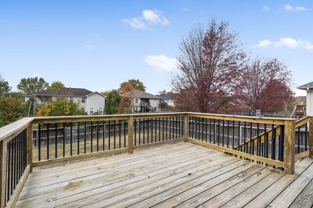 wooden terrace with a fenced backyard and a residential view