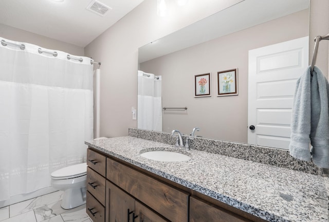 bathroom featuring vanity, walk in shower, and toilet