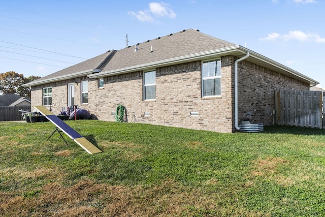 rear view of house featuring a lawn