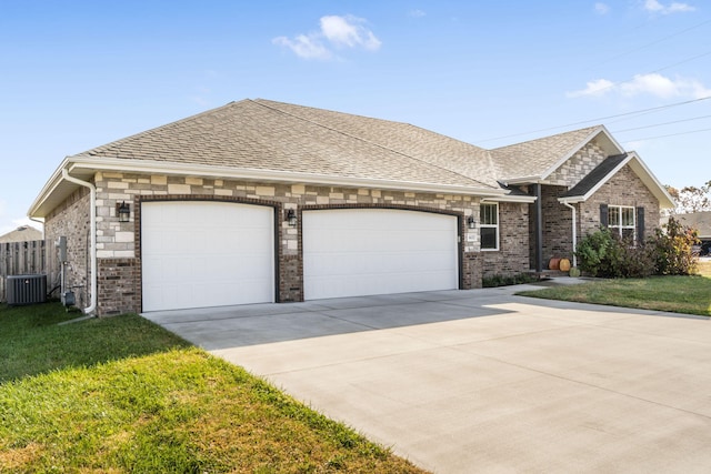 view of front of home featuring a front yard, a garage, and cooling unit