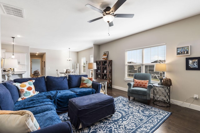 living room with dark hardwood / wood-style floors and ceiling fan