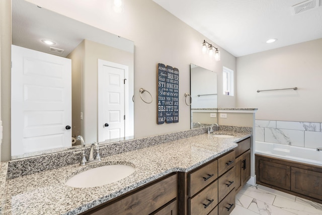 bathroom with vanity and a washtub