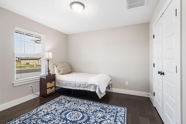 bedroom featuring a closet and dark hardwood / wood-style flooring