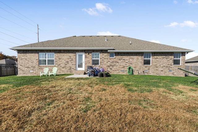 back of house featuring a patio and a lawn