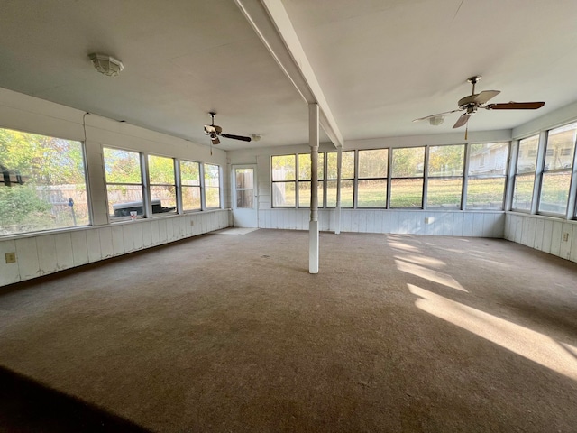 unfurnished sunroom with lofted ceiling with beams and ceiling fan