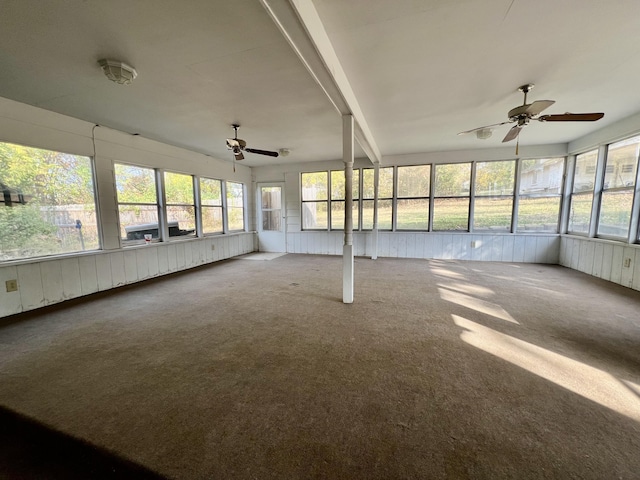 unfurnished sunroom with ceiling fan