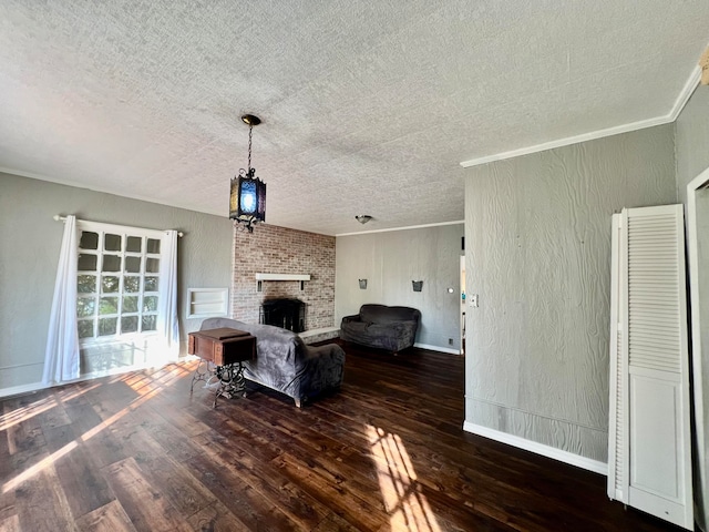 living room with ornamental molding, a textured ceiling, a fireplace, and dark hardwood / wood-style floors