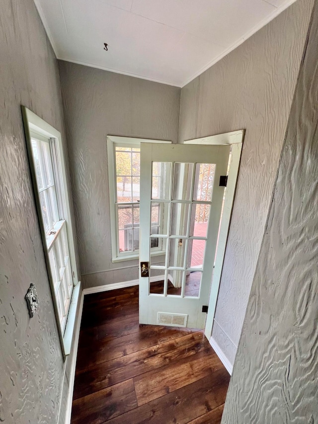 entryway featuring ornamental molding, french doors, and dark hardwood / wood-style floors