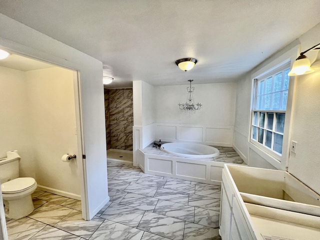 bathroom featuring a stall shower, toilet, and marble finish floor