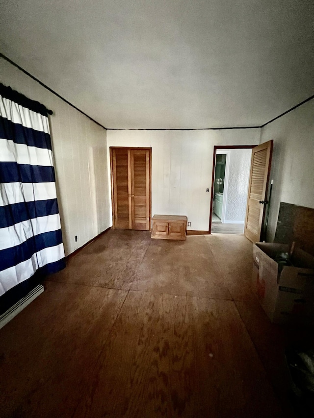 unfurnished living room with baseboards
