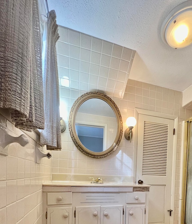 bathroom featuring vanity, tasteful backsplash, and tile walls