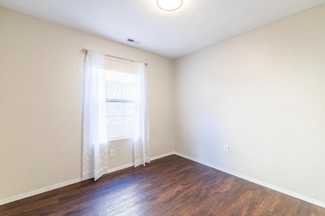 spare room featuring dark hardwood / wood-style flooring