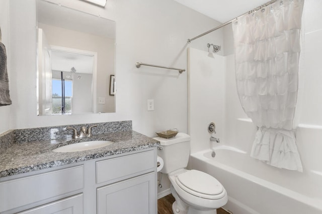 full bathroom featuring toilet, hardwood / wood-style floors, shower / bath combo with shower curtain, and vanity