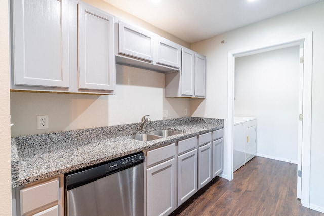 kitchen featuring light stone counters, stainless steel dishwasher, dark hardwood / wood-style floors, sink, and washer and clothes dryer