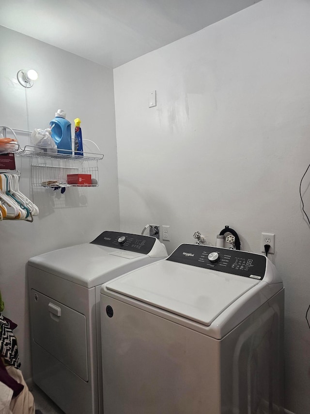 clothes washing area featuring washer and dryer