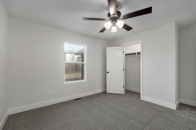 unfurnished bedroom featuring carpet flooring, ceiling fan, and a closet