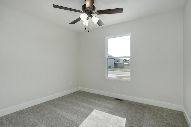 empty room featuring carpet floors and ceiling fan