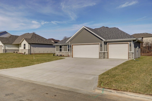 ranch-style house featuring a front lawn and a garage