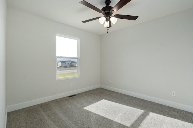 carpeted spare room with ceiling fan