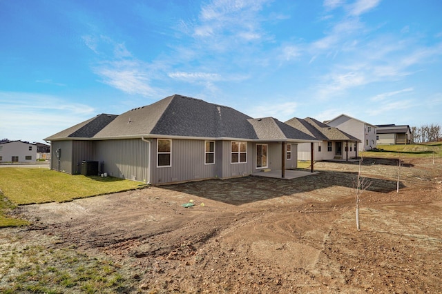 rear view of property featuring central AC unit and a patio