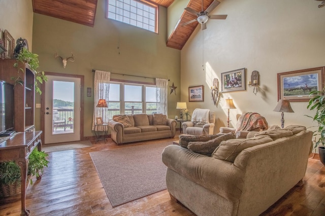 living room with wooden ceiling, hardwood / wood-style flooring, high vaulted ceiling, and ceiling fan