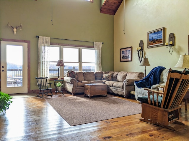 living room with a towering ceiling and light hardwood / wood-style flooring