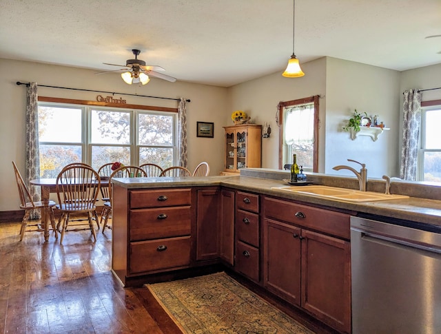 kitchen with ceiling fan, dishwasher, dark wood-type flooring, pendant lighting, and sink