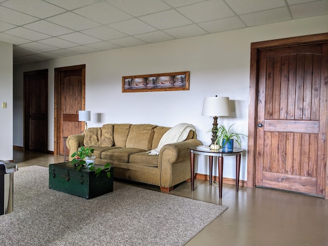 living room featuring a drop ceiling