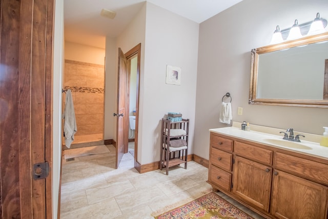 bathroom featuring vanity and tiled shower