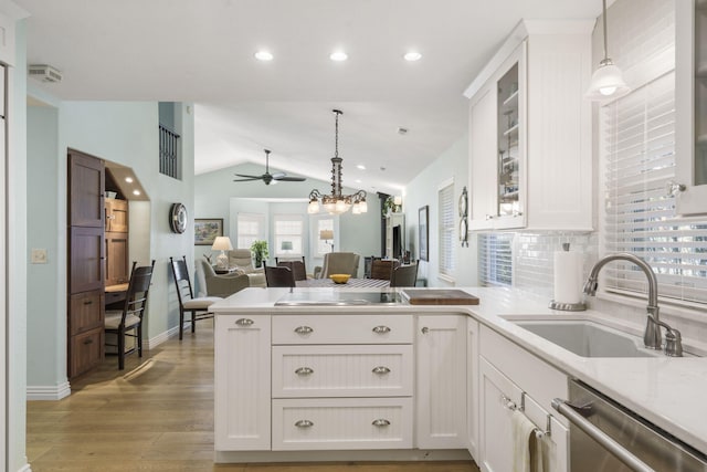 kitchen featuring white cabinets, plenty of natural light, and vaulted ceiling