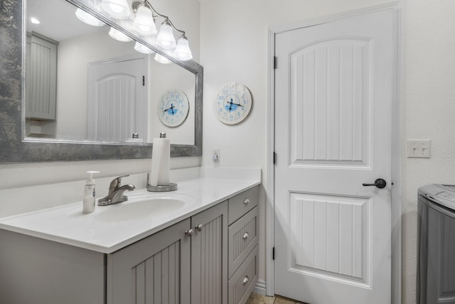 bathroom with vanity and separate washer and dryer