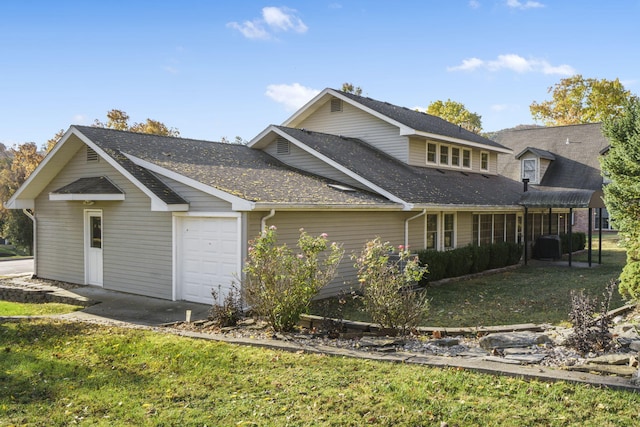 view of home's exterior with a garage and a lawn