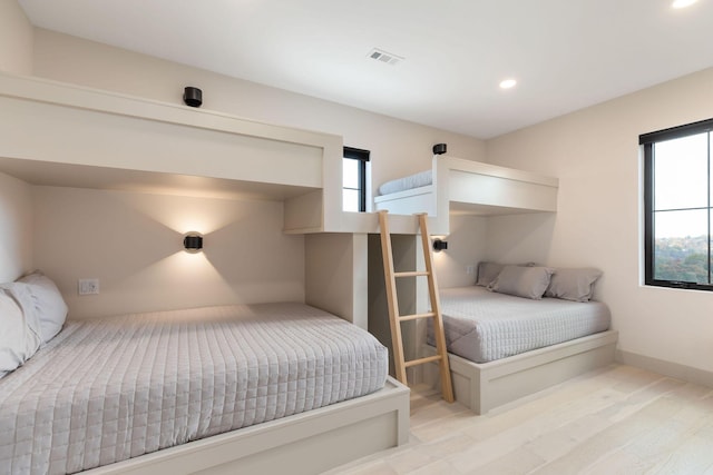 bedroom with multiple windows, recessed lighting, and visible vents