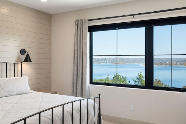 unfurnished bedroom with multiple windows and a water view