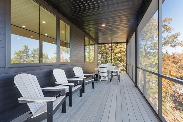 sunroom / solarium featuring outdoor dining area