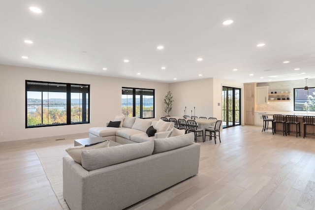 living area featuring light wood-type flooring and recessed lighting