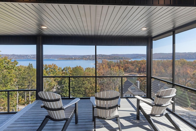 sunroom / solarium featuring a water view and plenty of natural light