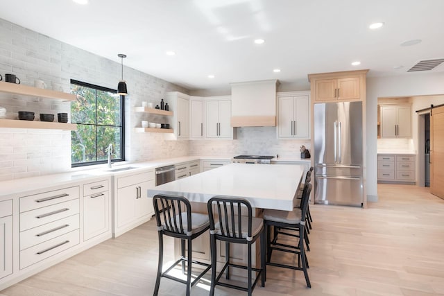 kitchen with tasteful backsplash, open shelves, visible vents, custom range hood, and appliances with stainless steel finishes