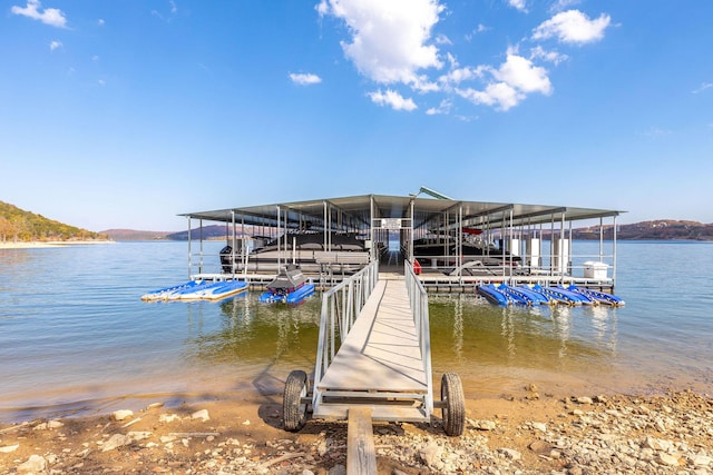 view of dock with boat lift and a water view