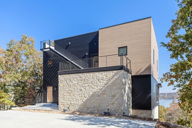 exterior space featuring a water view and a balcony