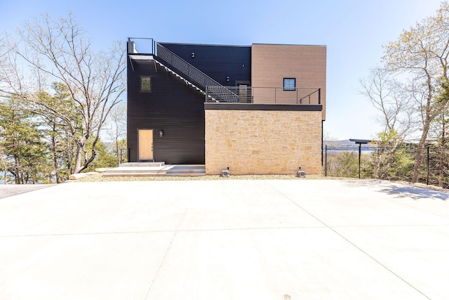 rear view of house with stone siding