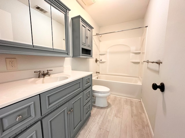 full bathroom with vanity, toilet, hardwood / wood-style flooring, and bathtub / shower combination