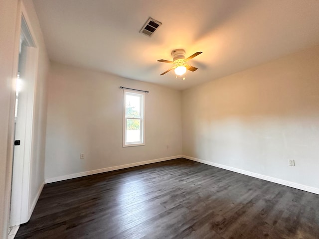 unfurnished room with ceiling fan and dark hardwood / wood-style flooring