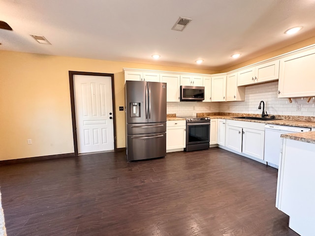 kitchen featuring decorative backsplash, stainless steel appliances, sink, white cabinets, and dark hardwood / wood-style flooring