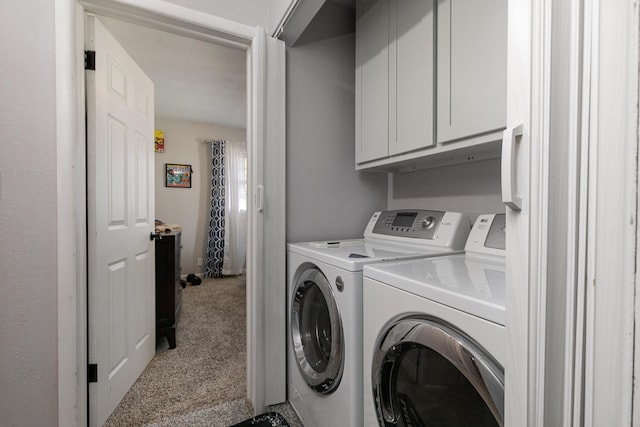 washroom with light carpet, washer and dryer, and cabinets