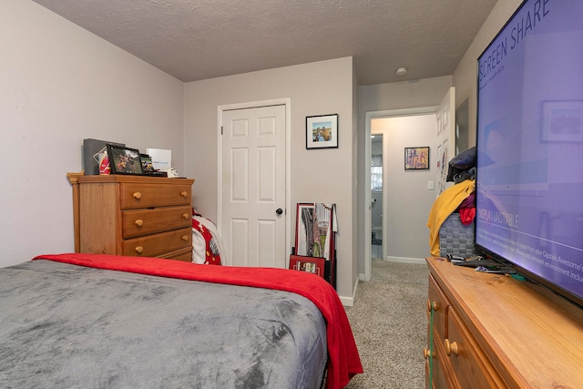 carpeted bedroom with a textured ceiling