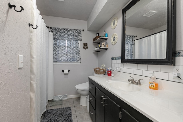 bathroom with a textured ceiling, toilet, tile patterned floors, vanity, and decorative backsplash